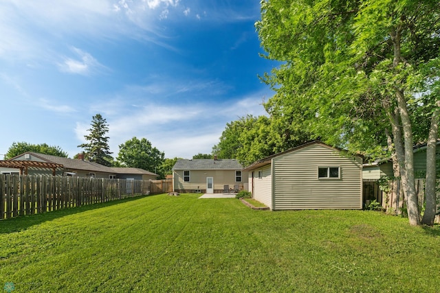 1636 2nd Ave S, Fargo, ND 58103 - fenced backyard with a patio and an outbuilding