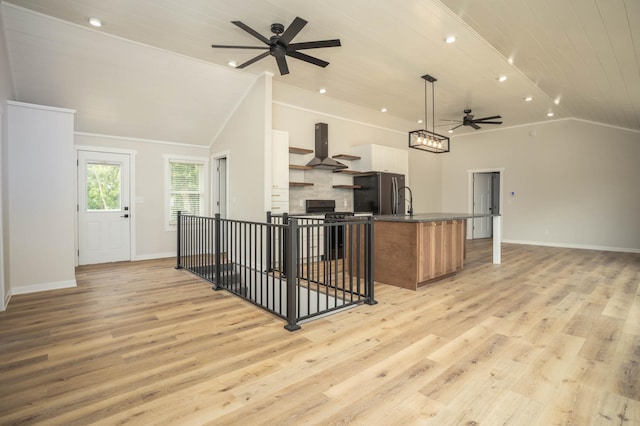 7591 Lake Ida Way NW, Alexandria, MN 56308 - kitchen featuring lofted ceiling, appliances with stainless steel finishes, open floor plan, a ceiling fan, and extractor fan