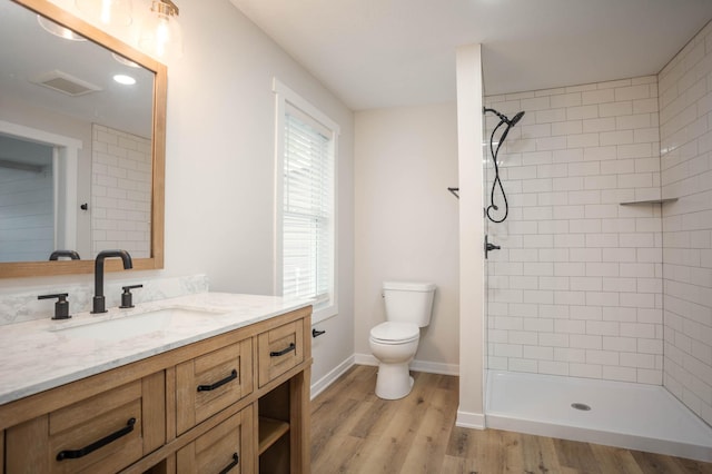 7591 Lake Ida Way NW, Alexandria, MN 56308 - full bath featuring vanity, a tile shower, and wood finished floors
