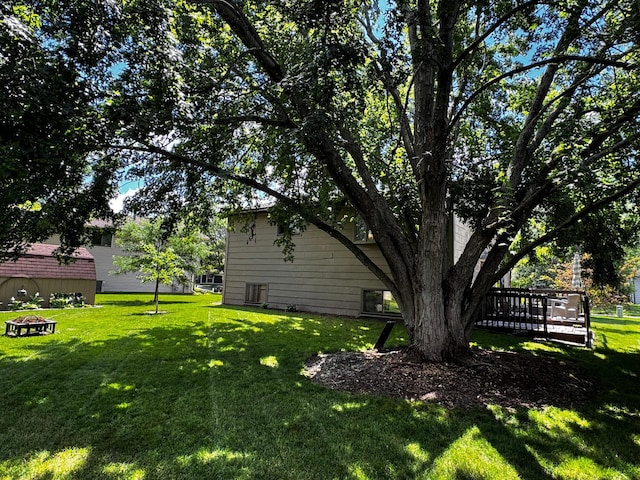 6314 112th Pl N, Champlin, MN 55316 - view of green lawn featuring an outdoor fire pit and a wooden deck