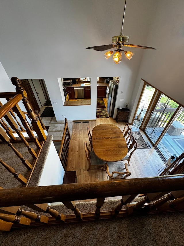 6314 112th Pl N, Champlin, MN 55316 - living room with a towering ceiling, wood finished floors, stairway, and ceiling fan