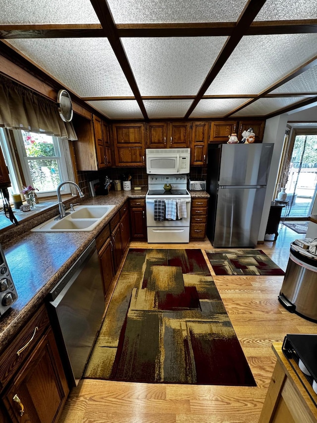 6314 112th Pl N, Champlin, MN 55316 - kitchen featuring appliances with stainless steel finishes, dark countertops, and wood finished floors