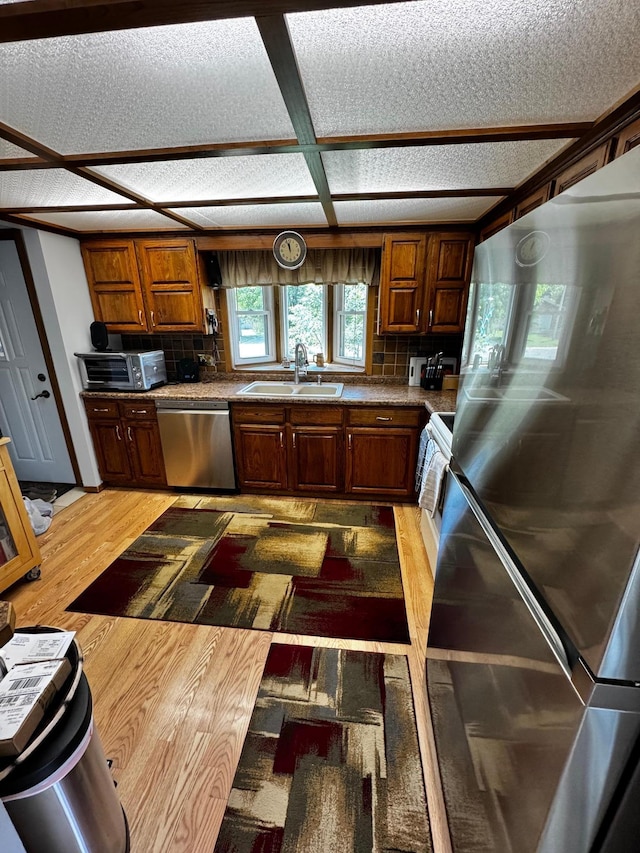 6314 112th Pl N, Champlin, MN 55316 - kitchen featuring appliances with stainless steel finishes, tasteful backsplash, and light wood-style floors