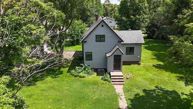 422 Park Ave, Sandstone, MN 55072 - view of front facade with roof with shingles, a front yard, and a chimney