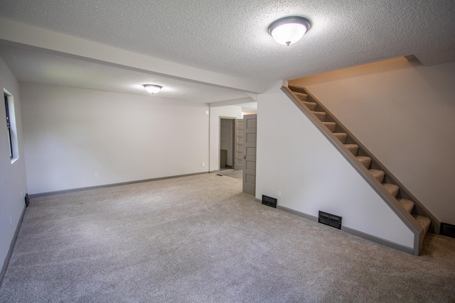 422 Park Ave, Sandstone, MN 55072 - finished basement with carpet, stairway, and a textured ceiling