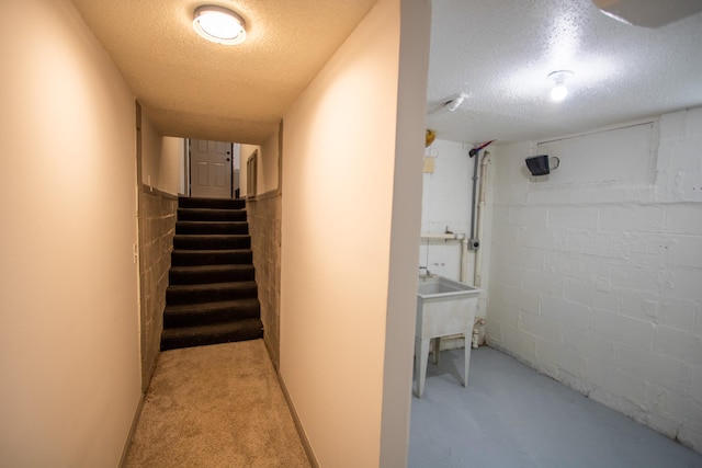 422 Park Ave, Sandstone, MN 55072 - stairway featuring concrete block wall and a textured ceiling