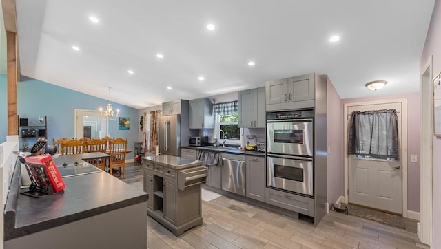 19421 708th Ave, Dassel, MN 55325 - kitchen with stainless steel appliances, gray cabinetry, dark countertops, a chandelier, and vaulted ceiling