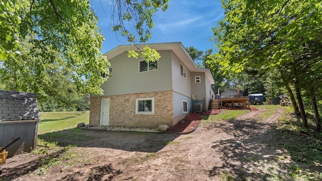 19421 708th Ave, Dassel, MN 55325 - view of home's exterior featuring stairway, brick siding, and a wooden deck