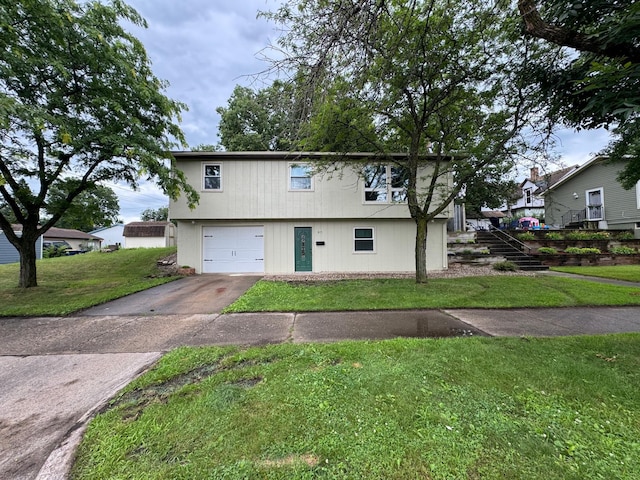 815 6th St N, New Ulm, MN 56073 - view of front facade with a garage, a front yard, concrete driveway, and stairway