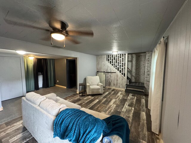 815 6th St N, New Ulm, MN 56073 - living area featuring stairs, wood finished floors, wooden walls, and a ceiling fan