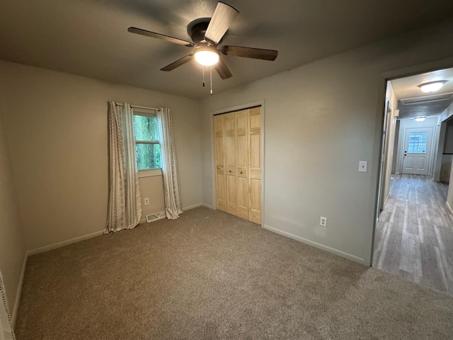 815 6th St N, New Ulm, MN 56073 - unfurnished bedroom featuring carpet floors, a closet, and a ceiling fan