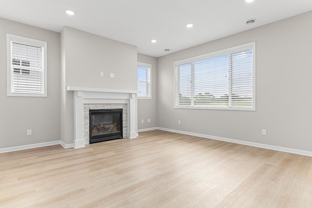 10070 32nd St NE, Saint Michael, MN 55376 - unfurnished living room featuring light wood finished floors, a fireplace, and recessed lighting