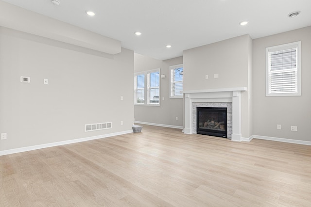 10070 32nd St NE, Saint Michael, MN 55376 - unfurnished living room with a glass covered fireplace, light wood finished floors, and recessed lighting