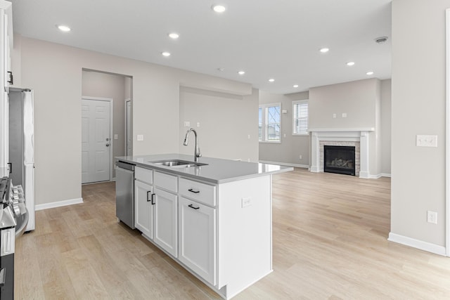 10070 32nd St NE, Saint Michael, MN 55376 - kitchen featuring stainless steel dishwasher, white cabinetry, light wood-style flooring, a kitchen island with sink, and recessed lighting