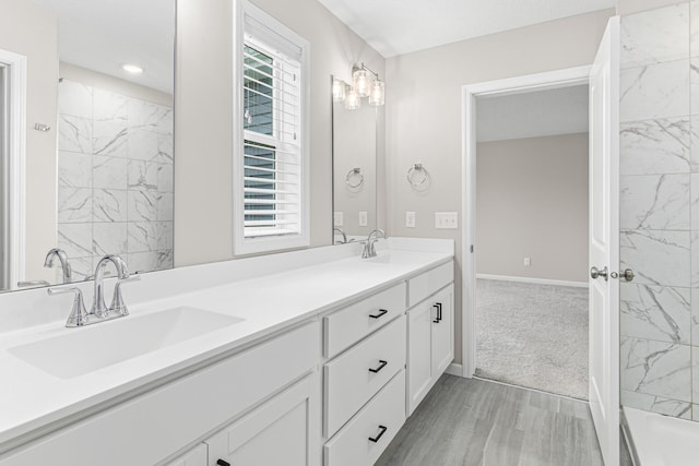 10070 32nd St NE, Saint Michael, MN 55376 - full bath with double vanity, wood finished floors, recessed lighting, and a tub