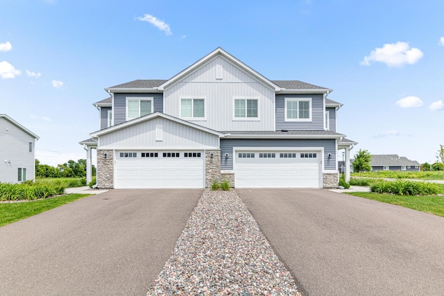 10070 32nd St NE, Saint Michael, MN 55376 - view of front of home featuring stone siding, asphalt driveway, and a garage