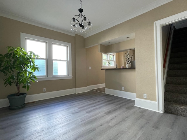 482 Edmund Ave, Saint Paul, MN 55103 - unfurnished room featuring a chandelier, ornamental molding, wood finished floors, stairway, and healthy amount of natural light