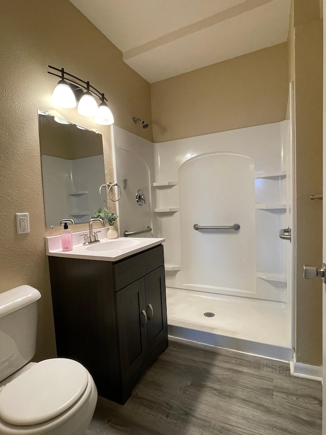 482 Edmund Ave, Saint Paul, MN 55103 - bathroom featuring a shower stall, vanity, and wood finished floors