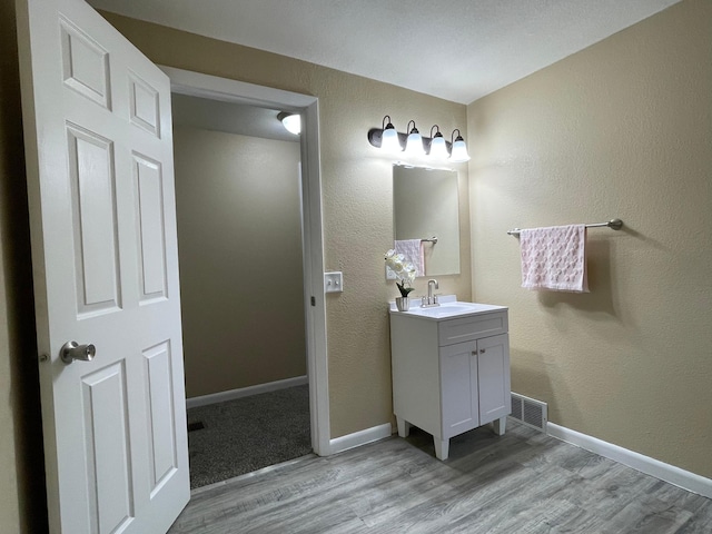 482 Edmund Ave, Saint Paul, MN 55103 - bathroom featuring vanity and wood finished floors