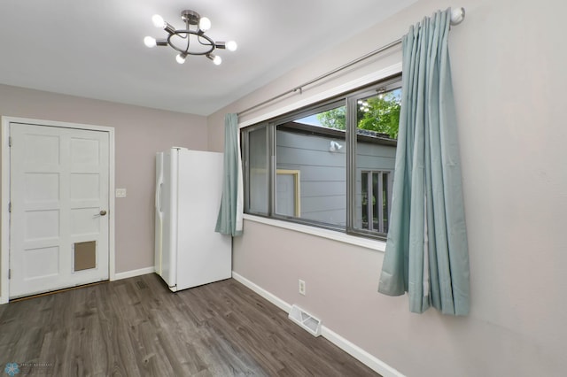219 10th Ave E, Fargo, ND 58078 - unfurnished dining area with a chandelier and wood finished floors