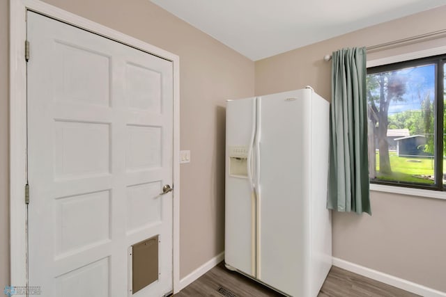 219 10th Ave E, Fargo, ND 58078 - kitchen featuring white refrigerator with ice dispenser and wood finished floors