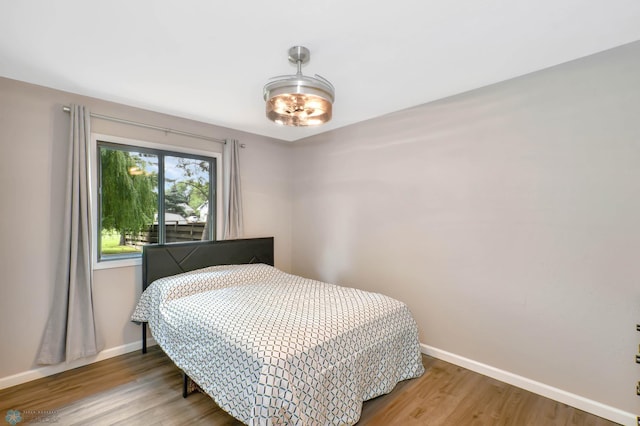 219 10th Ave E, Fargo, ND 58078 - bedroom featuring baseboards and wood finished floors