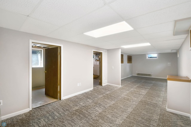 219 10th Ave E, Fargo, ND 58078 - below grade area featuring carpet, a drop ceiling, and a baseboard heating unit