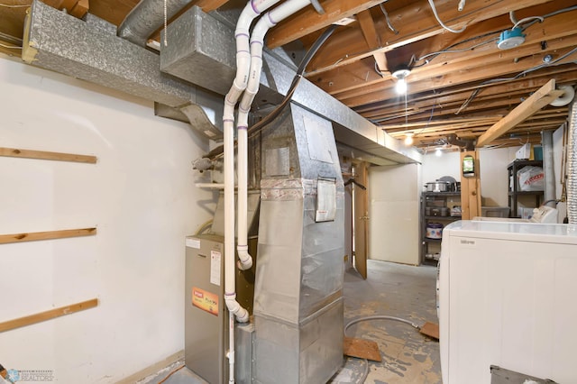 219 10th Ave E, Fargo, ND 58078 - unfinished below grade area featuring washer / dryer and heating unit