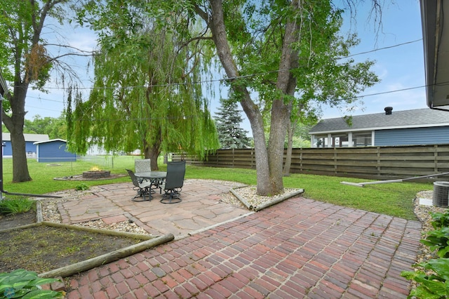 219 10th Ave E, Fargo, ND 58078 - fenced backyard featuring a patio area and a fire pit