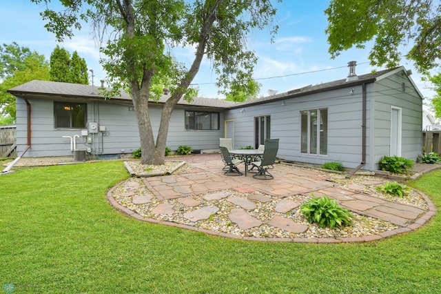 219 10th Ave E, Fargo, ND 58078 - back of property featuring a patio area and a lawn