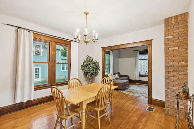 3331 34th Ave S, Minneapolis, MN 55406 - dining area featuring light wood-type flooring and a chandelier