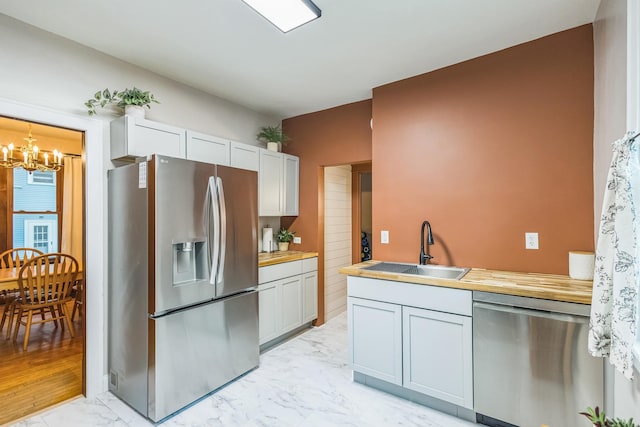 3331 34th Ave S, Minneapolis, MN 55406 - kitchen featuring appliances with stainless steel finishes, light marble finish floors, and a chandelier