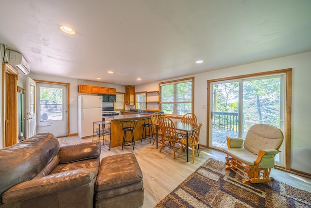 23546 Warbler Way Unit C1, Detroit Lakes, MN 56501 - living area with light wood finished floors, a wall mounted air conditioner, and recessed lighting
