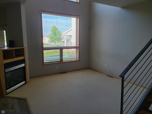 4394 46th Ave S Unit B, Fargo, ND 58104 - unfurnished living room with stairway, carpet floors, and a fireplace