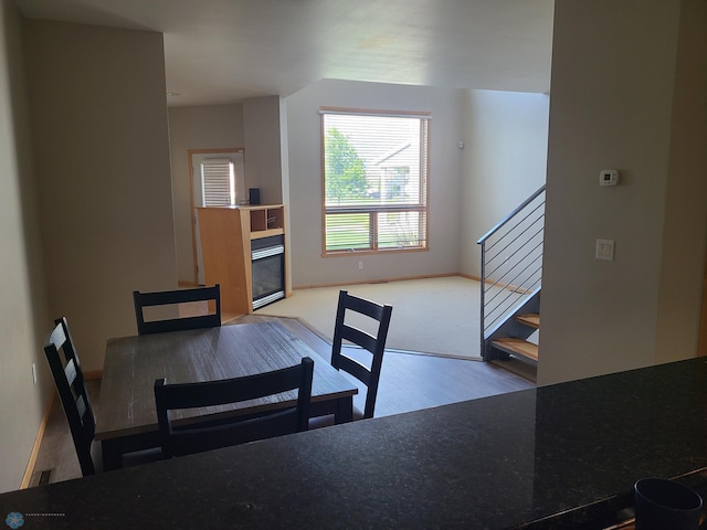 4394 46th Ave S Unit B, Fargo, ND 58104 - dining area with stairs, wood finished floors, and a tiled fireplace