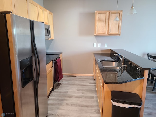 4394 46th Ave S Unit B, Fargo, ND 58104 - kitchen featuring appliances with stainless steel finishes, a peninsula, light brown cabinetry, and a kitchen bar