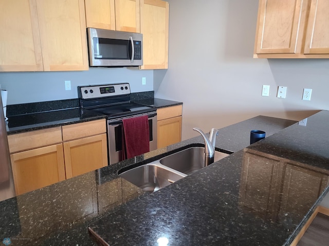 4394 46th Ave S Unit B, Fargo, ND 58104 - kitchen featuring appliances with stainless steel finishes, light brown cabinetry, and dark stone countertops