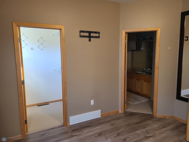 4394 46th Ave S Unit B, Fargo, ND 58104 - unfurnished bedroom with wood finished floors and connected bathroom