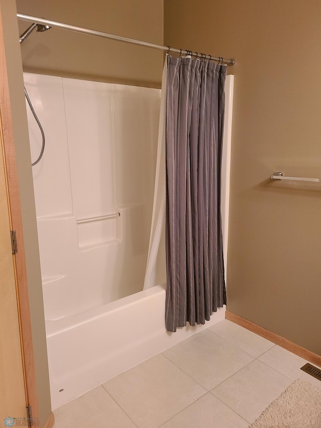 4394 46th Ave S Unit B, Fargo, ND 58104 - bathroom with shower / tub combo with curtain and tile patterned flooring