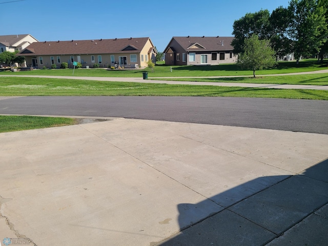 4394 46th Ave S Unit B, Fargo, ND 58104 - view of concrete driveway featuring a residential view and sidewalks