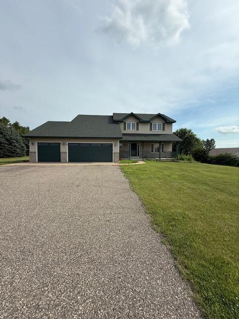 1355 Butterfly Ln, Spring Lake Twp, MN 55352 - view of front of home featuring asphalt driveway, a garage, a front yard, and a porch