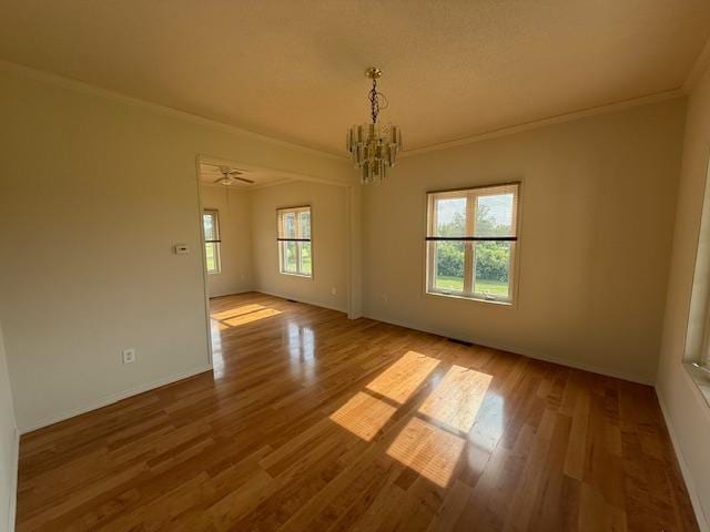 1355 Butterfly Ln, Spring Lake Twp, MN 55352 - empty room featuring crown molding, a chandelier, and wood finished floors