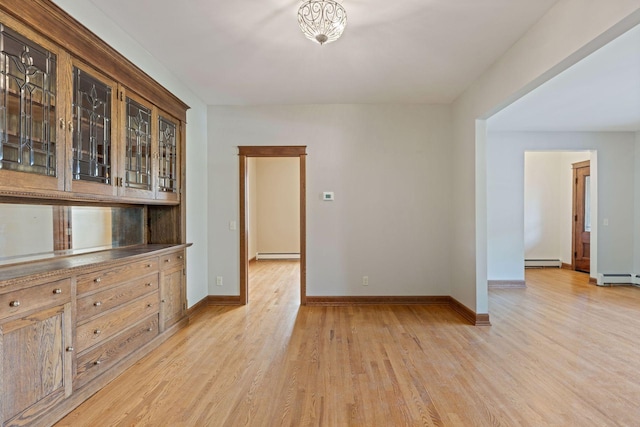 704-706 Holly Ave, Saint Paul, MN 55104 - spare room featuring light wood-type flooring and baseboard heating