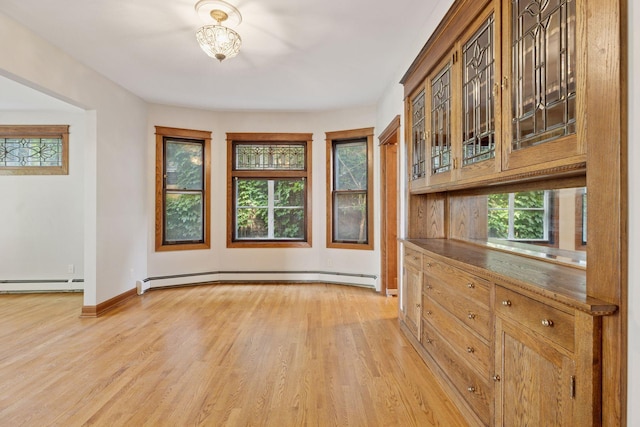 704-706 Holly Ave, Saint Paul, MN 55104 - unfurnished dining area featuring baseboard heating and light wood finished floors
