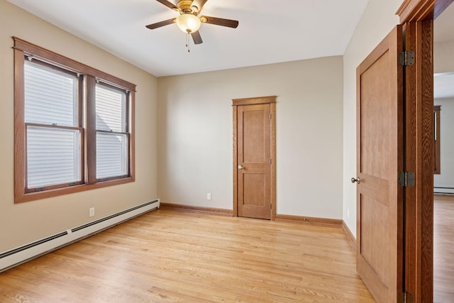 704-706 Holly Ave, Saint Paul, MN 55104 - unfurnished bedroom with a baseboard heating unit, light wood-style flooring, and a ceiling fan