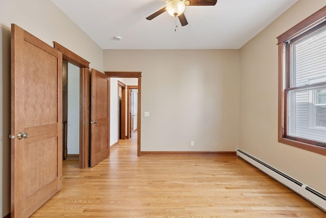 704-706 Holly Ave, Saint Paul, MN 55104 - empty room with baseboard heating, light wood-type flooring, ceiling fan, and a smoke detector