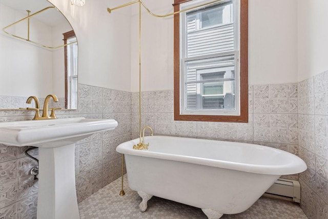 704-706 Holly Ave, Saint Paul, MN 55104 - full bath with a baseboard heating unit, healthy amount of natural light, tile walls, wainscoting, and a soaking tub