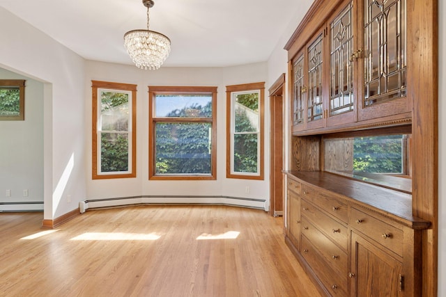 704-706 Holly Ave, Saint Paul, MN 55104 - unfurnished dining area featuring light wood-style flooring, a chandelier, and a baseboard radiator