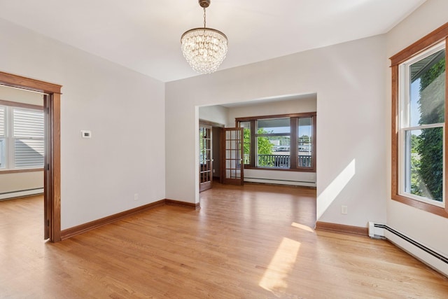 704-706 Holly Ave, Saint Paul, MN 55104 - spare room featuring a baseboard radiator, light wood-style flooring, and a chandelier