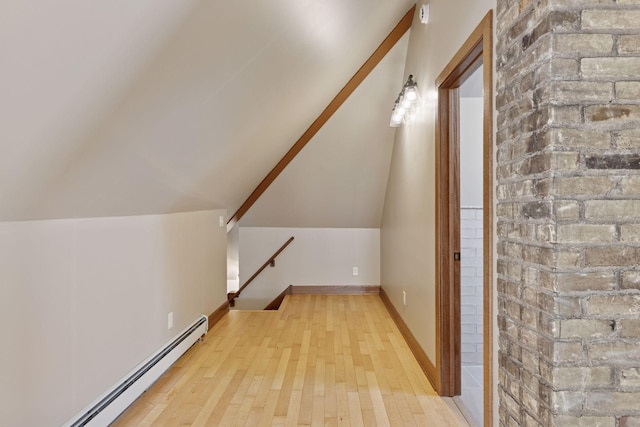 704-706 Holly Ave, Saint Paul, MN 55104 - additional living space with baseboard heating, wood finished floors, and lofted ceiling